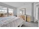 Bright bedroom with carpet, two windows with white curtains, dresser with light wood accents, and light colored walls at 23601 E Mississippi Cir, Aurora, CO 80018