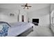 Large bedroom featuring vaulted ceiling, ceiling fan, mounted television, and ensuite bathroom at 23601 E Mississippi Cir, Aurora, CO 80018