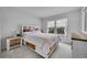Bright bedroom with two windows, a bed with built-in drawers, and a wooden headboard and nightstand at 23601 E Mississippi Cir, Aurora, CO 80018