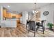 Open-concept dining area and kitchen featuring wood floors, modern lighting, and ample counter space at 23601 E Mississippi Cir, Aurora, CO 80018