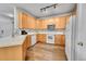 Functional kitchen featuring ample counter space, white appliances, wood cabinets, and natural light at 23601 E Mississippi Cir, Aurora, CO 80018