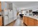 Open concept kitchen featuring stainless steel refrigerator and adjacent staircase at 23601 E Mississippi Cir, Aurora, CO 80018