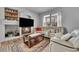 Inviting living room featuring a cozy fireplace, comfortable seating, and built in shelving at 23601 E Mississippi Cir, Aurora, CO 80018