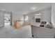 Cozy upstairs loft featuring gray sofa, carpeted floor, and natural light at 23601 E Mississippi Cir, Aurora, CO 80018