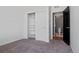 Bedroom with a neutral carpet, features closet with sliding doors, and bathroom entrance at 23744 E Ida Pl # E, Aurora, CO 80016