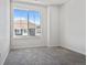 Carpeted bedroom features a large window with great natural light and views of other modern homes at 23744 E Ida Pl # E, Aurora, CO 80016