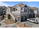 Multi-level home featuring attached garages and stone accents at 23744 E Ida Pl # E, Aurora, CO 80016