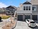 Modern townhome boasts a private garage and entryway stairs in a community with contemporary architecture at 23744 E Ida Pl # E, Aurora, CO 80016