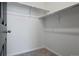Empty walk-in closet offers ample storage space with shelving and hanging rods for organized storage at 23744 E Ida Pl # E, Aurora, CO 80016