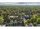 Aerial view of home with lush trees and downtown in distance at 445 Forest St, Denver, CO 80220