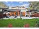Expansive backyard featuring a covered patio, outdoor kitchen, and lush landscaping at 445 Forest St, Denver, CO 80220