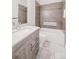 Neutral bathroom features stylish vanity with drawers and a combined shower and tub at 445 Forest St, Denver, CO 80220