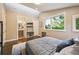 Modern bedroom with large windows, ensuite bath, and wood floors at 445 Forest St, Denver, CO 80220