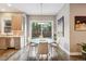 Cozy dining nook with backyard views, modern lighting, and seamless transition to adjacent kitchen at 445 Forest St, Denver, CO 80220