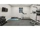 Well-lit exercise room featuring modern equipment, including a treadmill and weight rack at 445 Forest St, Denver, CO 80220