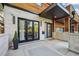 Modern stone and wood home exterior with a spacious front porch area and a contemporary outdoor rug at 445 Forest St, Denver, CO 80220