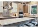Modern kitchen with stone countertops, unique lighting, custom cabinets, and stainless steel appliances at 445 Forest St, Denver, CO 80220