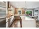 Spacious kitchen with a large island, stainless steel appliances, and sliding glass doors to the backyard at 445 Forest St, Denver, CO 80220