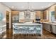 Modern kitchen featuring a large island, stainless steel appliances, custom cabinets, and unique backsplash at 445 Forest St, Denver, CO 80220