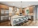 Spacious kitchen boasts stainless steel appliances, large island with seating, and ample countertop space at 445 Forest St, Denver, CO 80220