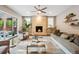 Bright living room boasts a fireplace, modern ceiling fan, hardwood floors, and access to the outdoor space at 445 Forest St, Denver, CO 80220