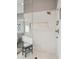 Modern shower with glass enclosure, neutral tiles, and bronze fixtures at 445 Forest St, Denver, CO 80220
