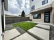 Landscaped backyard with green grass, gravel, and concrete pavers, providing a stylish outdoor space at 960 Quitman St, Denver, CO 80204