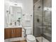 Modern bathroom featuring a glass-enclosed shower, wood vanity with sink, and sleek fixtures at 960 Quitman St, Denver, CO 80204