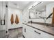 Modern bathroom featuring a glass shower, floating vanity with gray counters and black hardware, and stylish fixtures at 960 Quitman St, Denver, CO 80204
