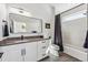 Stylish bathroom features a modern vanity with sleek fixtures and a shower tub with a dark shower curtain at 960 Quitman St, Denver, CO 80204