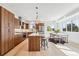 Spacious kitchen with modern wood cabinets, stainless steel appliances, and a large island at 960 Quitman St, Denver, CO 80204