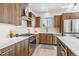 Modern kitchen featuring wood cabinets, stainless steel appliances, quartz countertops, and lots of natural light at 960 Quitman St, Denver, CO 80204