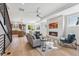 Bright living space with wood floors, fireplace, and open layout to the kitchen, perfect for entertaining and relaxation at 960 Quitman St, Denver, CO 80204