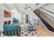 Stylish living room featuring modern furnishings, fireplace, open staircase and hardwood floors throughout at 960 Quitman St, Denver, CO 80204