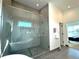 Luxury walk-in shower features a large glass door, sleek tile, and built-in niches for storage at 960 Quitman St, Denver, CO 80204