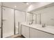 Modern bathroom features a double vanity, tub, and glass shower at 15228 Detroit St, Thornton, CO 80602