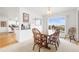Bright dining area with a wooden table, four chairs, and a large window offering pleasant views of the exterior at 23753 E 155Th Way, Brighton, CO 80603