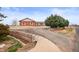 The driveway is paved and leads up to the charming brick home at 23753 E 155Th Way, Brighton, CO 80603
