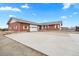 Charming brick home featuring a well-kept driveway, and an attached garage, showcasing great curb appeal at 23753 E 155Th Way, Brighton, CO 80603
