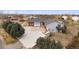 Expansive ranch-style home showcasing a large driveway, mature landscaping, and a private deck overlooking the property at 23753 E 155Th Way, Brighton, CO 80603