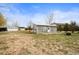 Back view of property with a charming building surrounded by green grass at 23753 E 155Th Way, Brighton, CO 80603