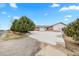 Spacious home featuring a wide driveway leading to an attached garage, complemented by mature trees for added privacy at 23753 E 155Th Way, Brighton, CO 80603