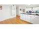 Bright kitchen features white cabinets, black countertops and hardwood floors at 23753 E 155Th Way, Brighton, CO 80603