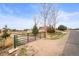 A spacious, gated property featuring a charming brick home with a generous yard and mature trees at 23753 E 155Th Way, Brighton, CO 80603