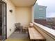 Cozy balcony with a wooden bench, chair, and rug offering a relaxing outdoor space at 3701 Arapahoe Ave # 304, Boulder, CO 80303