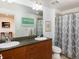 Bathroom with dual sinks, granite counters, and shower/tub combo at 3701 Arapahoe Ave # 304, Boulder, CO 80303