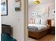 Bedroom with neutral walls, accent art, and a glimpse of a closet and living area at 3701 Arapahoe Ave # 304, Boulder, CO 80303