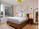 Bedroom with large window, neutral walls, wood trim, and wood furnishings at 3701 Arapahoe Ave # 304, Boulder, CO 80303