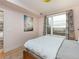 Cozy bedroom boasts light pink walls and large window with city view at 3701 Arapahoe Ave # 304, Boulder, CO 80303