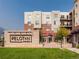 Modern building exterior with lush landscaping, signage and manicured lawns at 3701 Arapahoe Ave # 304, Boulder, CO 80303